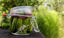 Pickles In A Jar With Bitter Pepper And Inflorescence Of Wild Garlic On A Wooden Surface Selective Focus, Fermented Vegetables