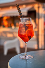 Glass of orange fresh spritz drink cocktail on a beach bar. Food and drink concept