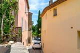 Fototapeta Uliczki - A narrow street winding to the top of the medieval town of Grimaud, France.