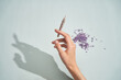 © Pietro Karras/Stocksy - Making marijuana substitute joint with lilac flowers