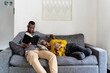 © Ezequiel Giménez/Stocksy - Black couple chilling on sofa together