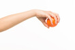 © serhii - female hands holding an orange sponge ball on a white background isolated