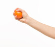 © serhii - female hands holding an orange sponge ball on a white background isolated