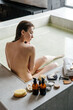 © Sergey Narevskih/Stocksy - Woman washing hair with soap in bathtub