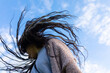 © Demetr White/Stocksy - girl dancing against the sky