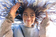 © Demetr White/Stocksy - portrait of a happy girl from below