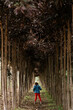 © Ezequiel Giménez/Stocksy - Anonymous girl walking along trees