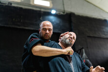 Martial Artists Practicing Throat Cutting