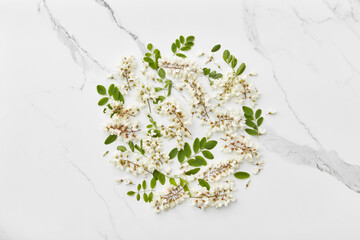 Acacia blooms on marble surface.