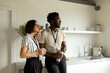 © Valentina Barreto/Stocksy - Mixed couple having coffee at office kitchen