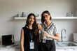 © Valentina Barreto/Stocksy - Two partners in office kitchen portrait