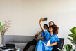 © Valentina Barreto/Stocksy - Business team taking selfie in cowork space