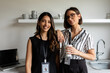 © Valentina Barreto/Stocksy - Colleagues in office drinking coffee