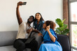 © Valentina Barreto/Stocksy - Colleagues taking selfie in cowork space