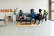 © Valentina Barreto/Stocksy - Business group resting at cowork office