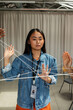 © Valentina Barreto/Stocksy - Asian woman with intertwined threads at work
