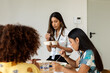 © Valentina Barreto/Stocksy - Female co-workers at lunch time in office