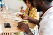 © Valentina Barreto/Stocksy - Diverse people at office lunch break
