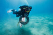 © Jovana Milanko/Stocksy - Egyptian man carrying a tire and trash collected at ocean cleanup