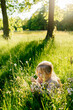 © Sergey Narevskih/Stocksy - Child picking flowers in meadow