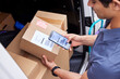 © ALTO IMAGES/Stocksy - Cropped delivery man scanning barcode on parcel