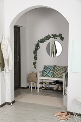 Sticker - Hallway interior with stylish furniture and round mirror on light wall