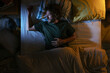 © BONNINSTUDIO/Stocksy - Man sleeping in bed at night
