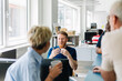 © Studio Firma/Stocksy - Colleagues Talking in Office