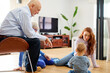 © Guille Faingold/Stocksy - Family playing with baby at home.