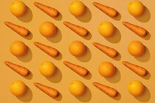 Carrot And Orange On Yellow Color Background