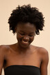 © ohlamour studio/Stocksy - Shy woman smiling and looking down