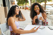 © Lupe Rodríguez/Stocksy - multiracial friends drinking coffee outside a cafeteria