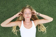 © Rene de Haan/Stocksy - young woman relaxing on grass