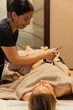 © Shava Cueva/Stocksy - Therapist smiling giving a cavitation massage