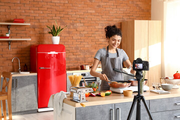 Sticker - Young woman cooking pasta while recording cooking video class in kitchen