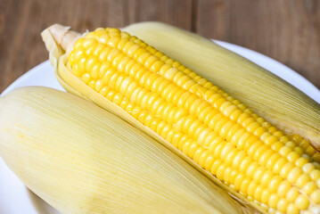 Wall Mural - cooked sweet corn background, ripe corn cobs steamed or boiled sweetcorn for food vegan dinner or snack