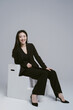 © ZQZ Studio/Stocksy - Portrait of young woman wearing suit