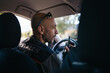 © Pedro Merino/Stocksy - Forest service man in uniform talking on walkie talkie in car