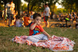 © Jelena Jojic Tomic/Stocksy - Kids on a summer picnic in a park