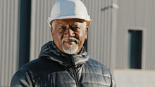 Portrait Of Elderly African American Confident Man Professional Engineer Construction Worker In Safety Helmet Successful Builder Contractor Foreman Standing Outdoors Site Close-up Looking At Camera