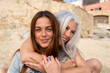 © Alba Vitta/Stocksy - Portrait of mature  mother and adult daughter at the beach