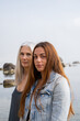 © Alba Vitta/Stocksy - Portrait of mature  mother and adult daughter at the beach