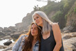 © Alba Vitta/Stocksy - Portrait of mature  mother and adult daughter at the beach
