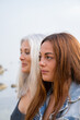 © Alba Vitta/Stocksy - Portrait of mature  mother and adult daughter at the beach