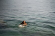 © Alba Vitta/Stocksy - happy Woman swimming in the sea