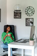 © David Prado/Stocksy - black woman drinking coffee while working on computer