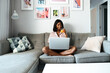 © David Prado/Stocksy - Black woman using laptop at home