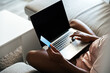 © David Prado/Stocksy - Crop woman with credit card using laptop