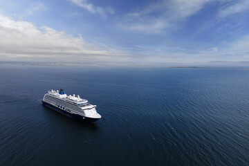 cruise ship in the ocean. blue cloudy sky. tourism and travel concept. elegant voyage by water. aeri