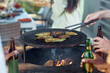 © Seventyfour - Close up of young people grilling vegetables during barbeque party outdoors in Summer, copy space